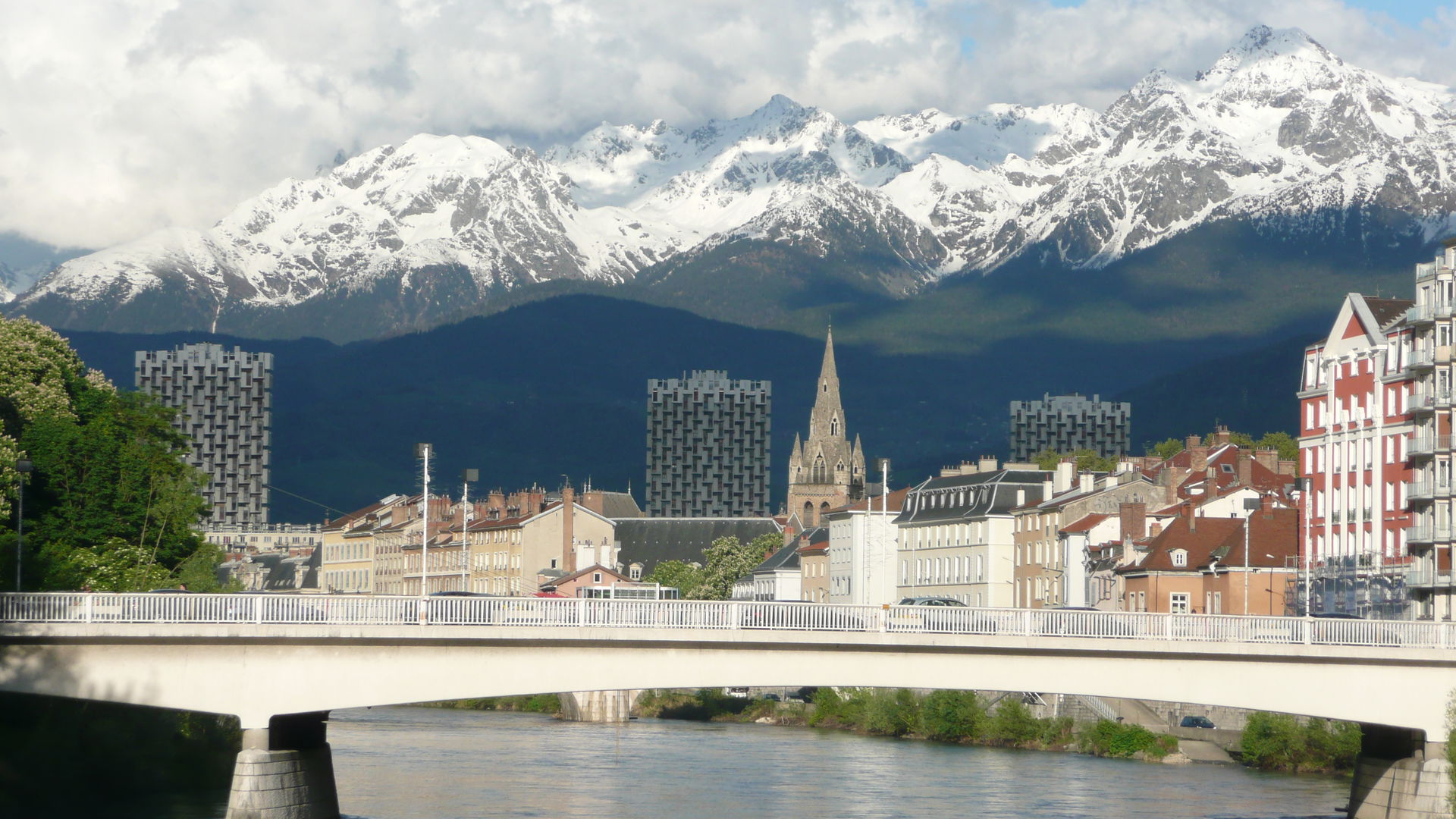 Grenoble with bridge over Isere and view of Alpes