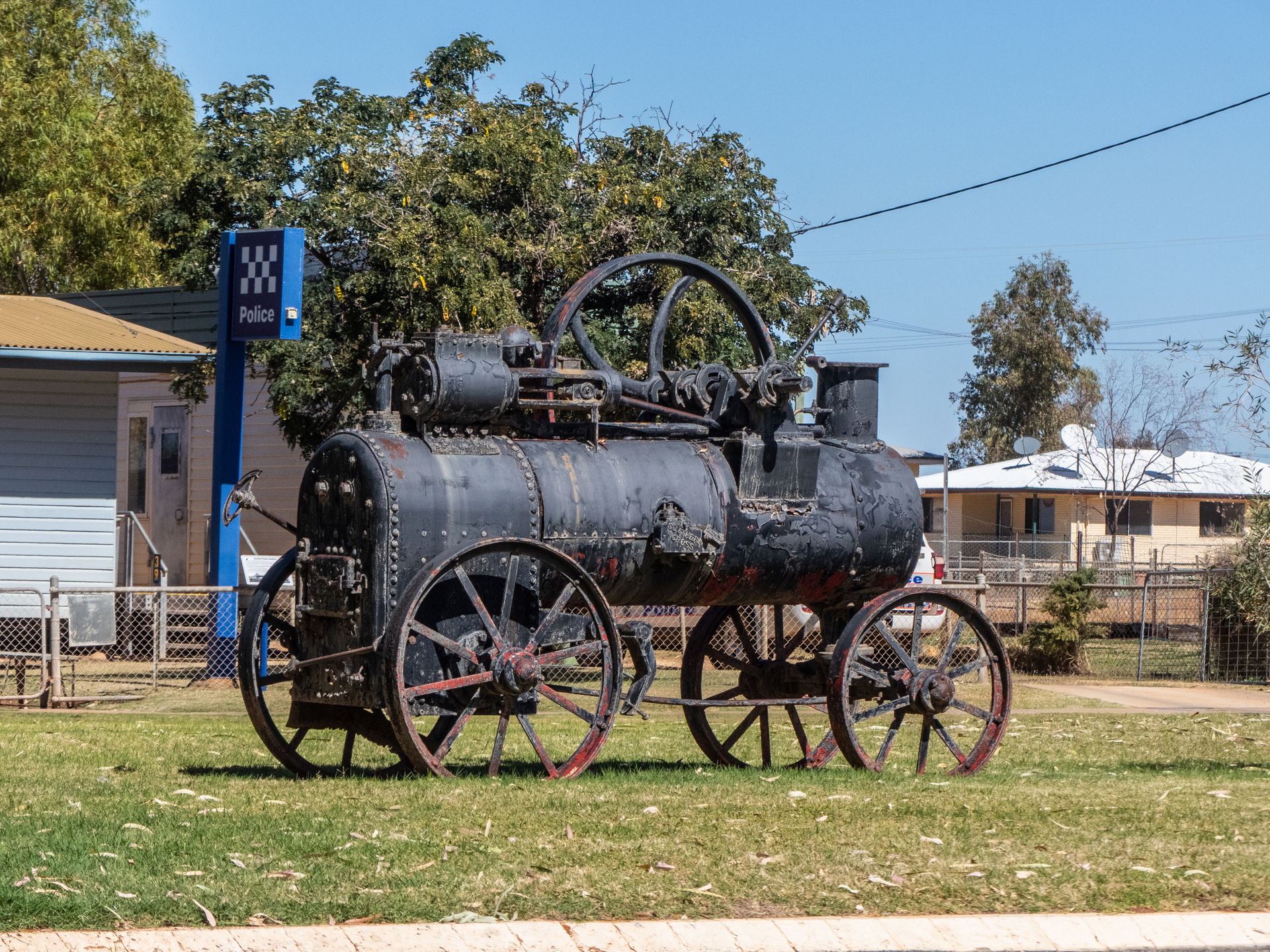 A vintage steam traction engine sits in the median strip of Her…