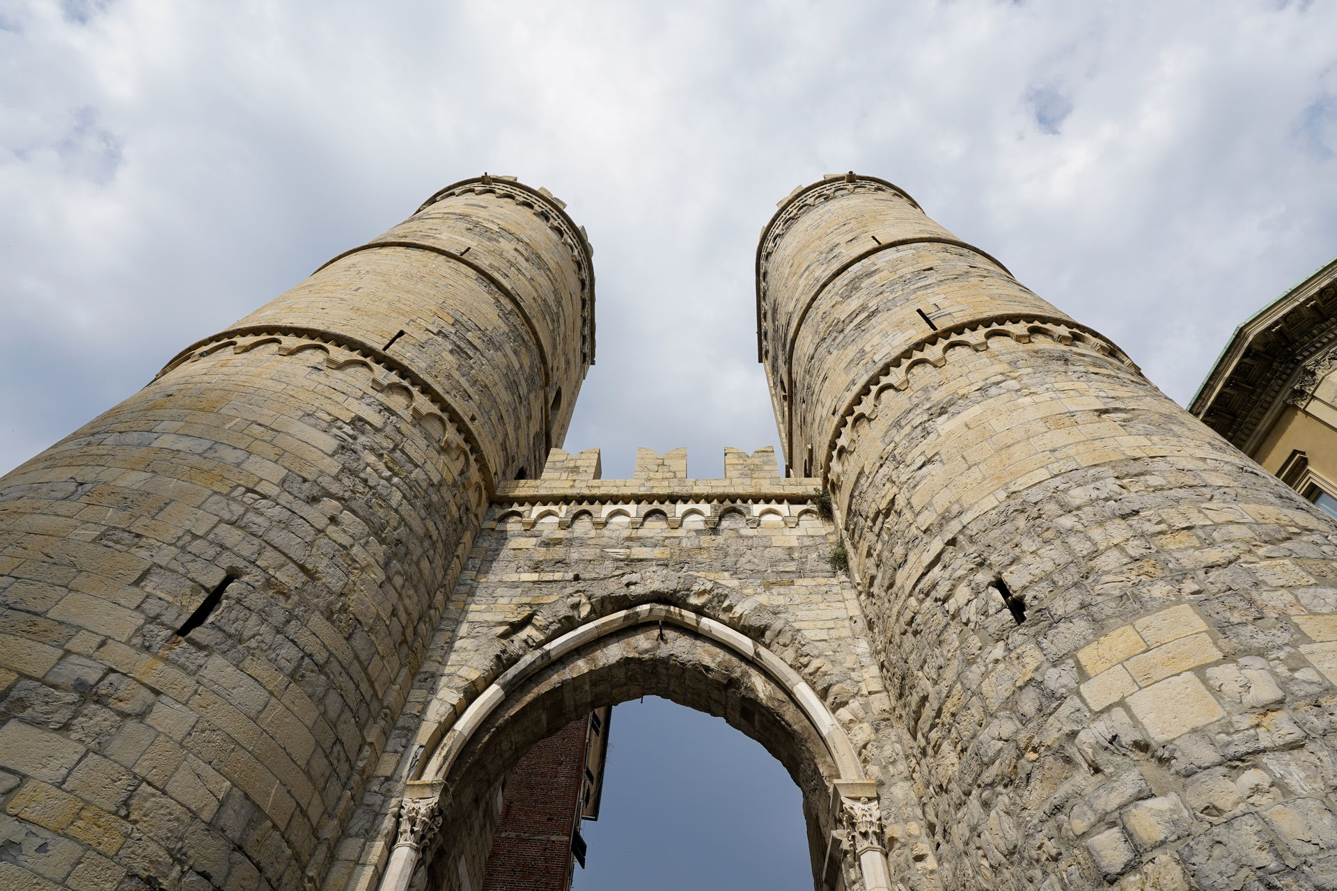 A close-up exterior view of the Porta Soprana with its stone wa…