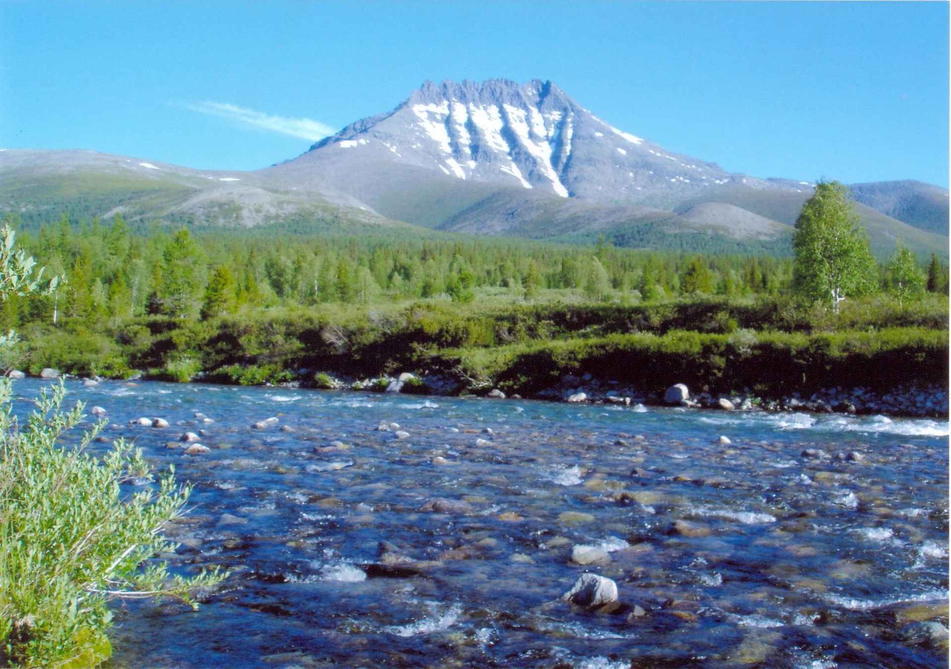 View over a river near the village Saranpaul, with Mount Manara…