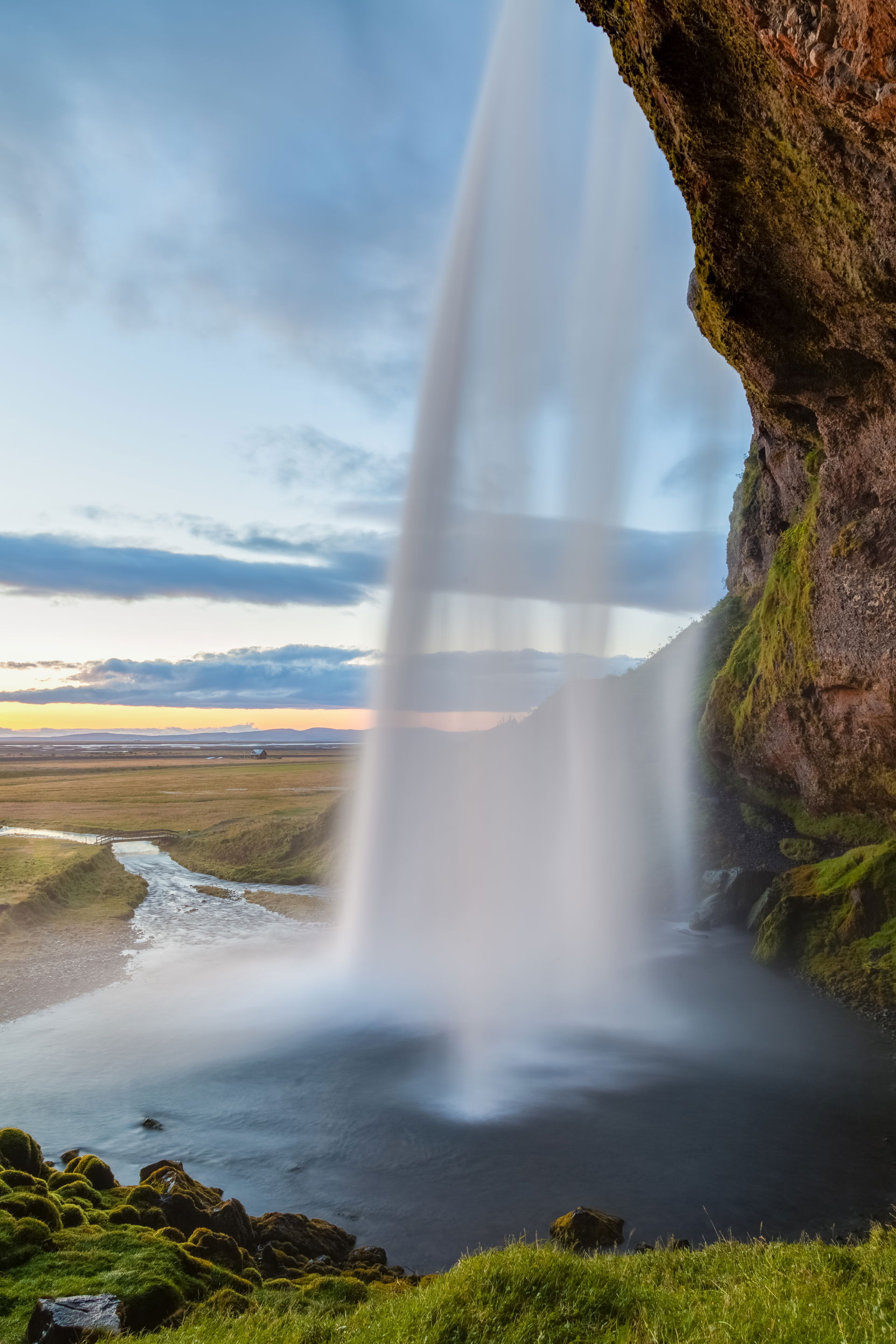 Lateral view of the Seljalandsfoss waterfall during a sunset, S…