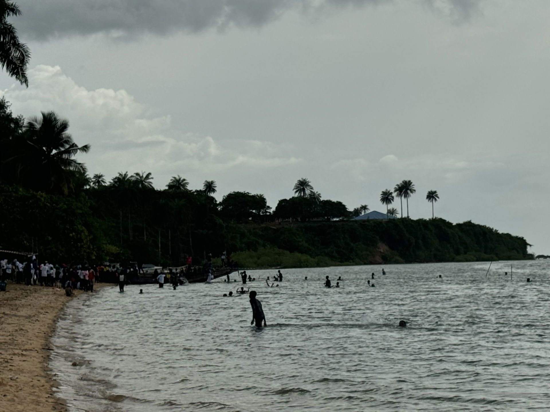 People swimming and gathering on a beach of Bubaque, Bijagós Ar…