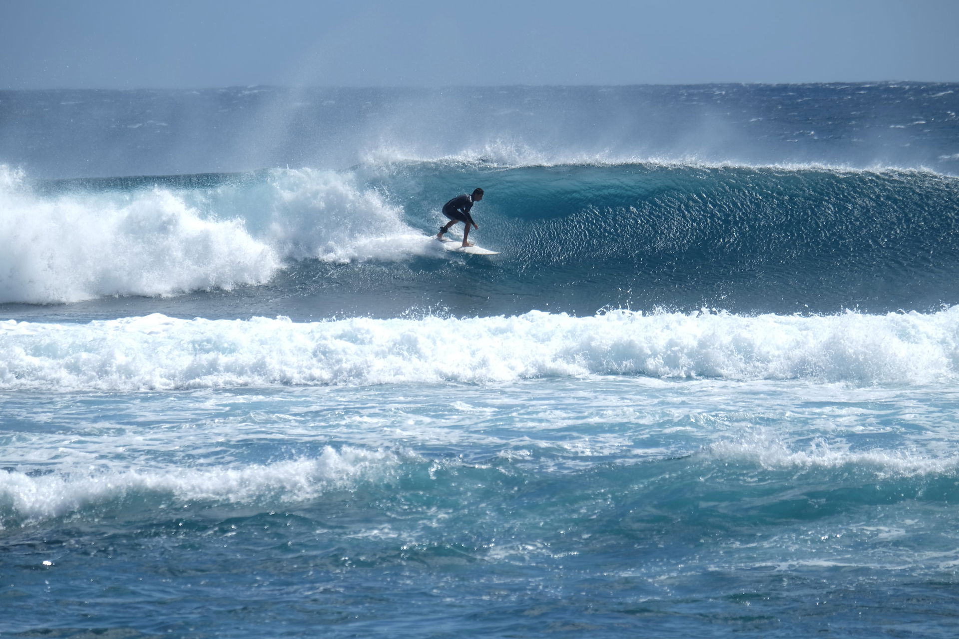 Surfer on a tube wave (left), riding at the "La Tortue" spot, R…