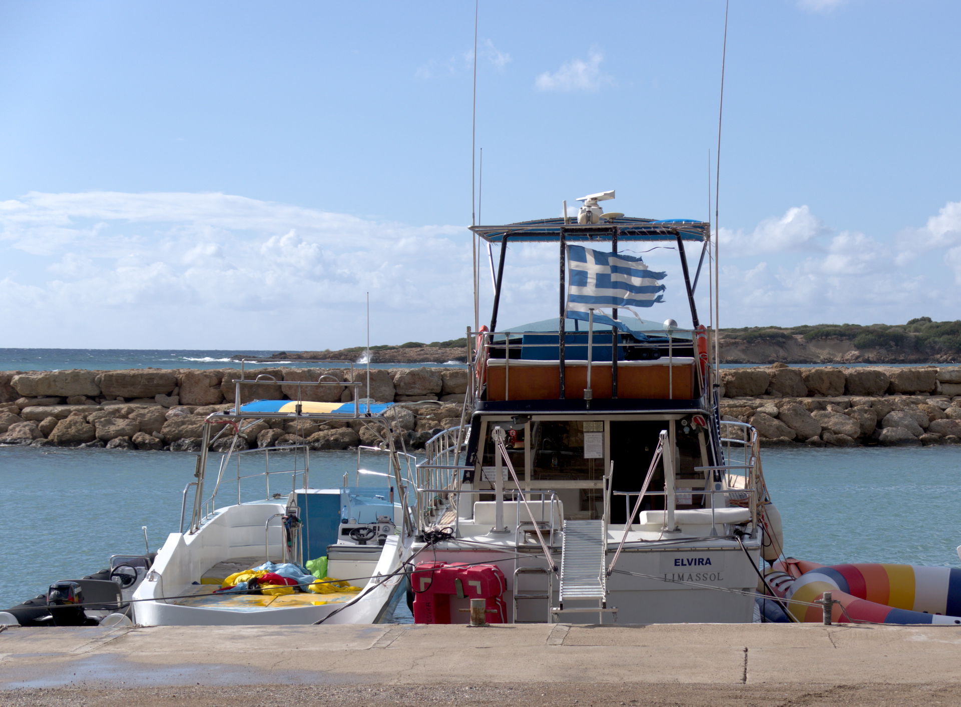 Boats in front of Coral Beach Hotel & Resort and Limani Tav…