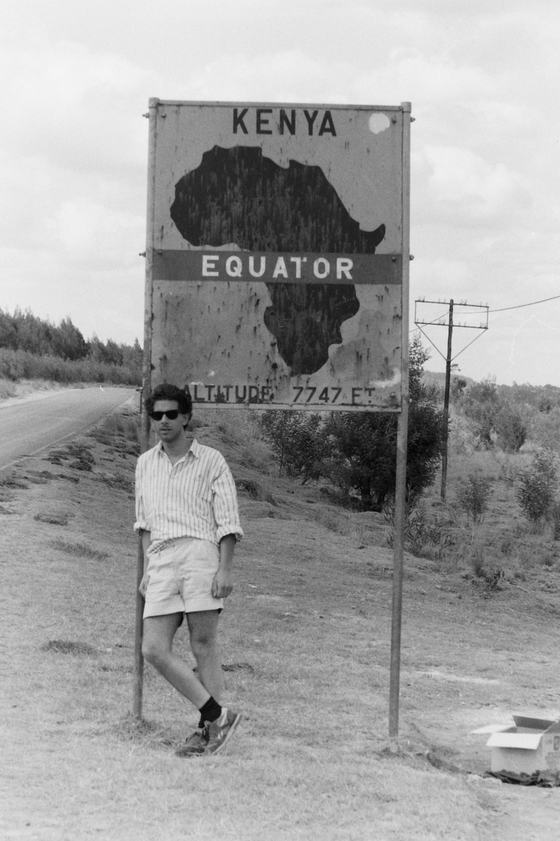 TAHIR SHAH STANDING AT THE EQUATOR IN KENYA, 1986