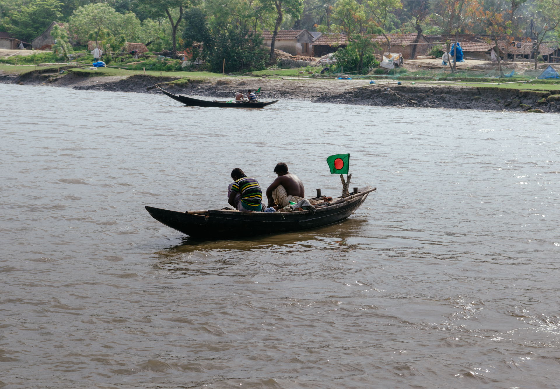 Two Bangladeshi fisherman tending their nets on their country b…