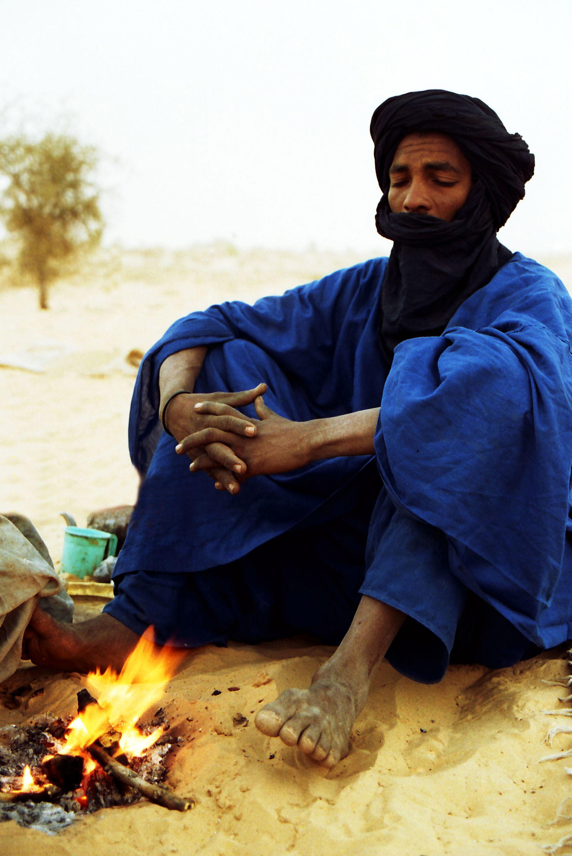 A Tuareg in northern Mali prepares a fire for making tea, Sahar…