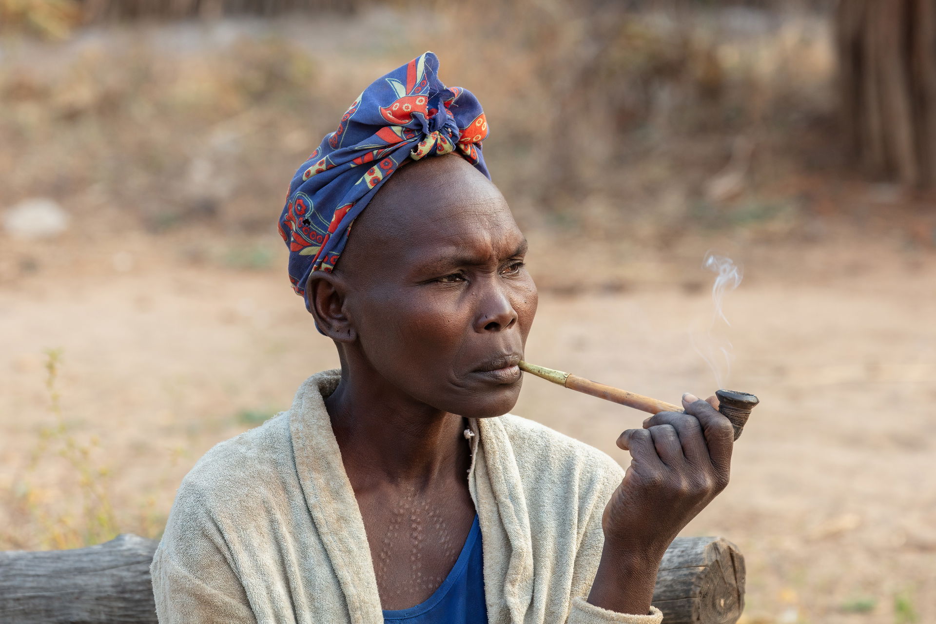 Adult woman of the Laarim Tribe smoking in a pipe, Kimotong, So…