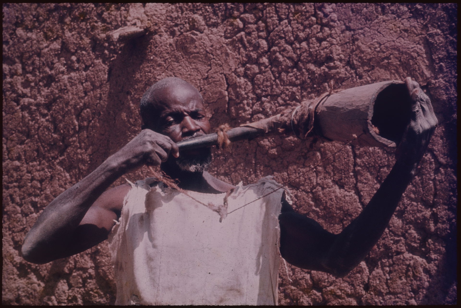 A Samo man playing the war horn, Burkina Faso, 1970-1971. Simil…
