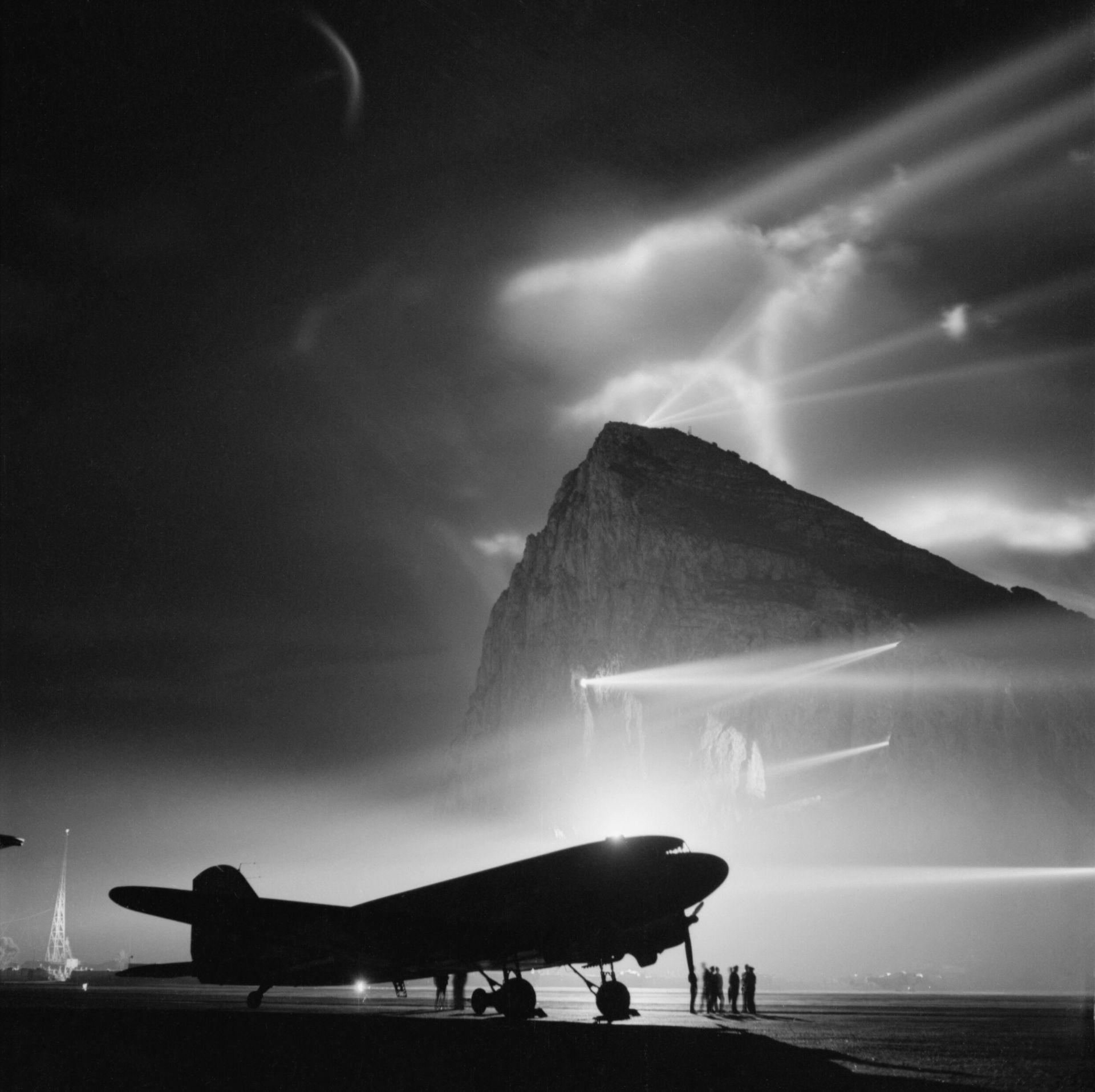 A Douglas Dakota of BOAC at Gibraltar, silhouetted by searchlig…