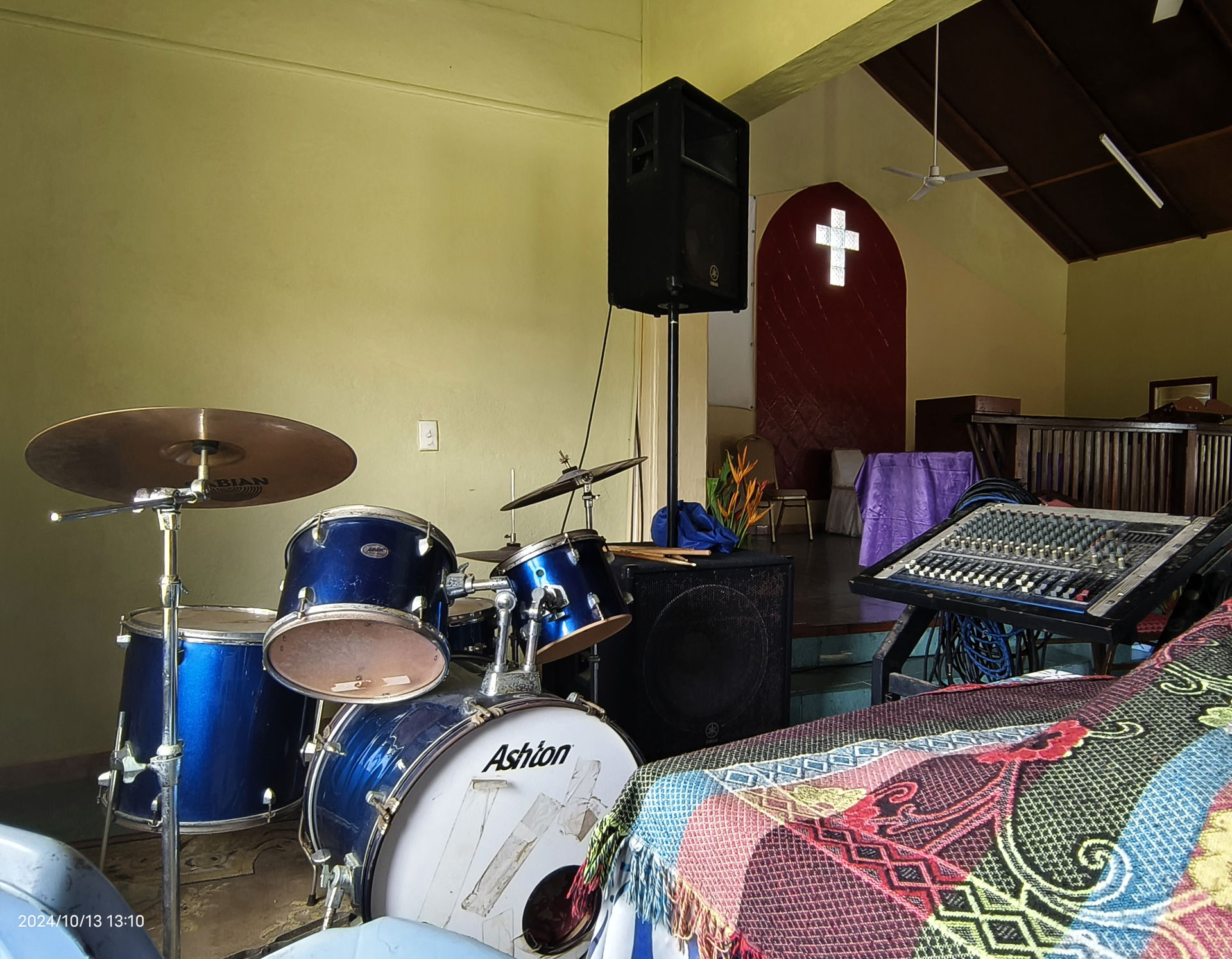 Interior of a church in Vanuatu, with a cross and a drum set.