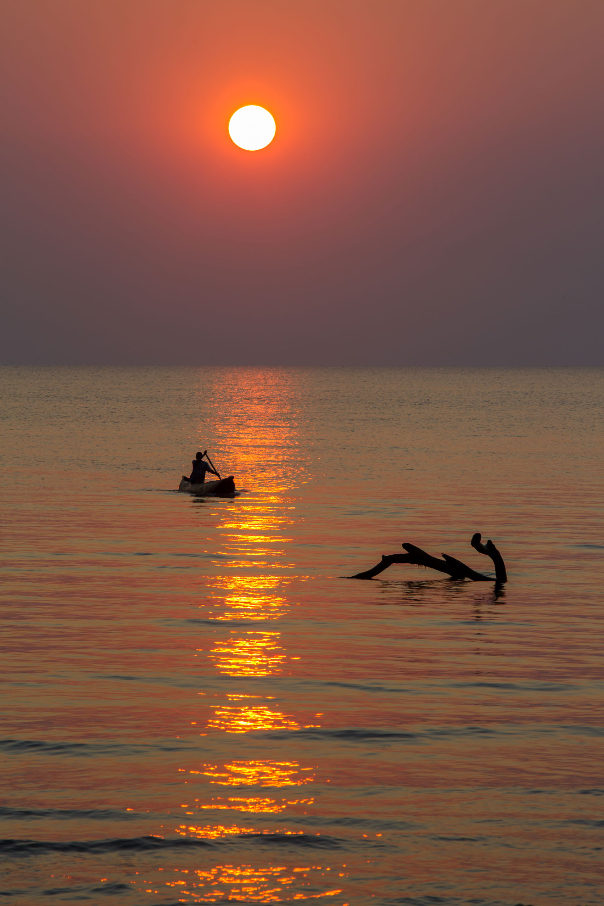 Malawi - sunrise at lake malawi - a fishermen in a traditional …