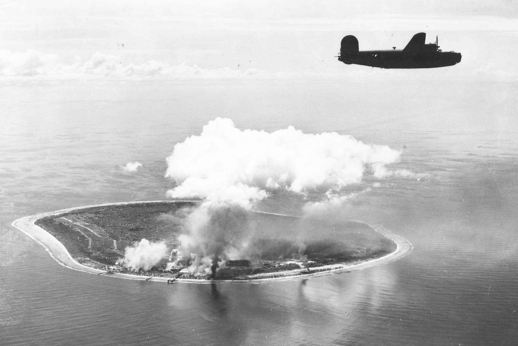A 7th Air Force B-24 heads for home after a strike against faci…