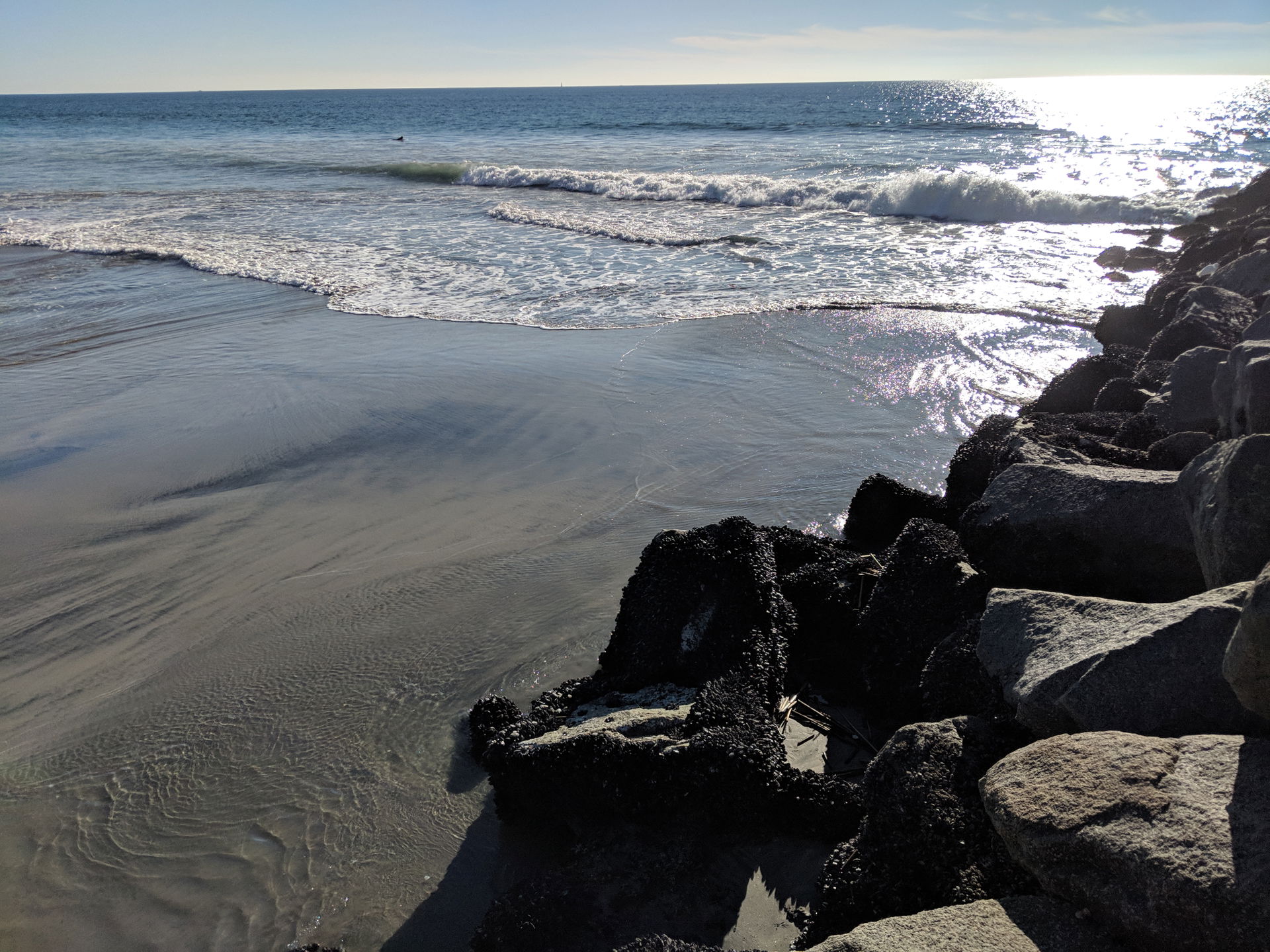 An elevated rocky path jutting out into the Pacific Ocean from …