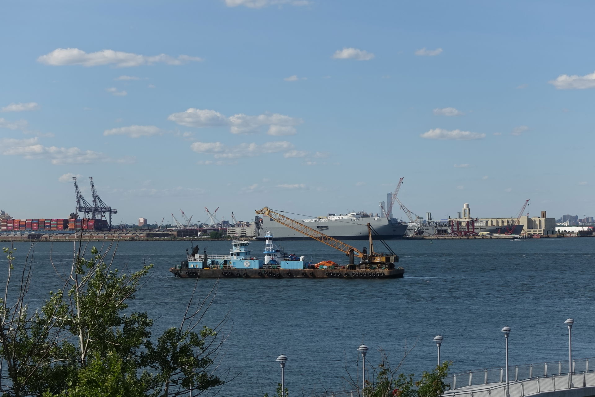 Looking east at a barge traveling east from the Kill Van Kull i…