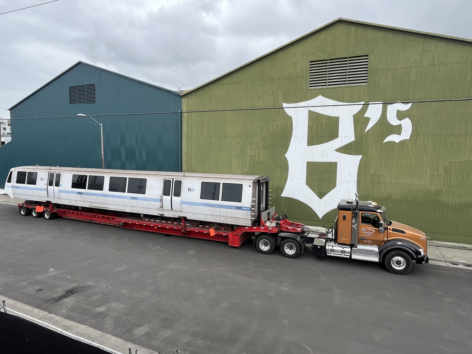 A decommissioned Bay Area Rapid Transit car on a flatbed truck,…