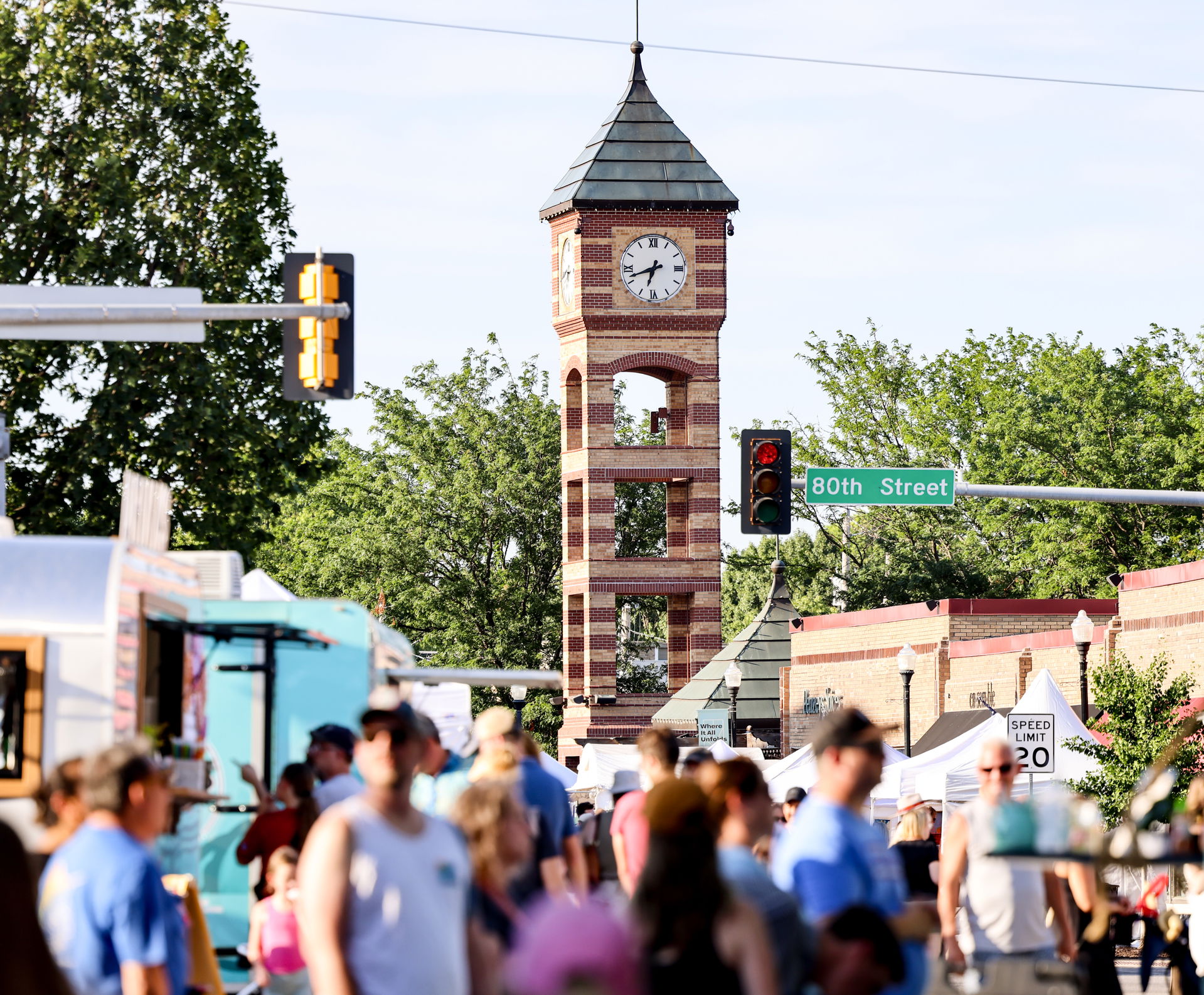 A street in downtown Overland Park with people walking and a cl…