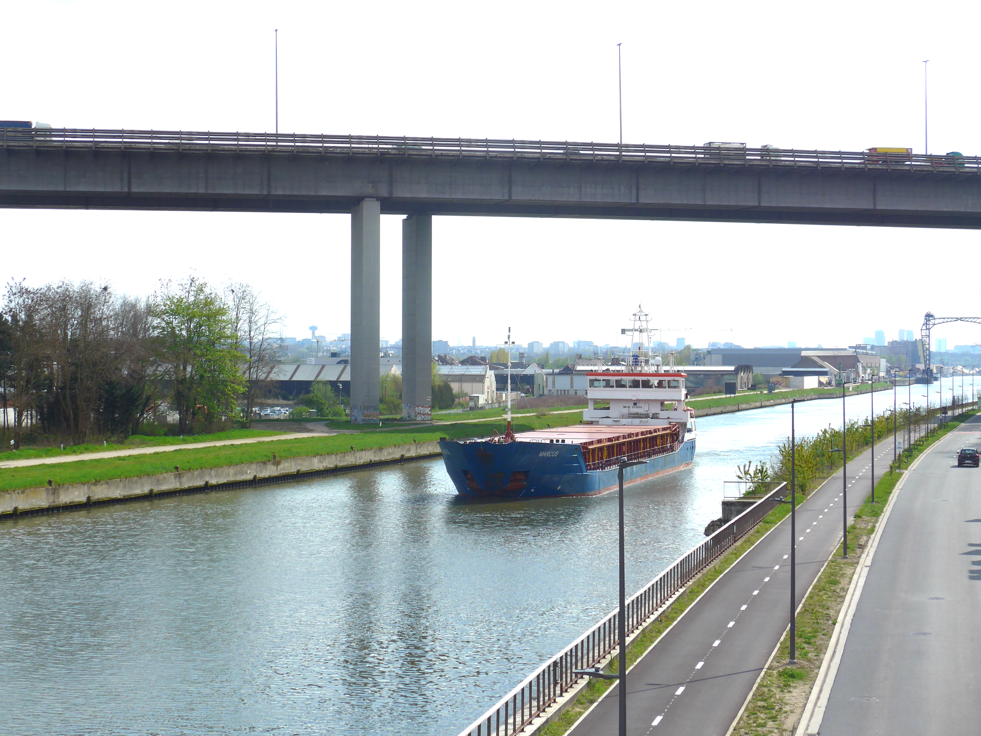 A marine vessel sails underneath the viaduct of Vilvoorde, havi…