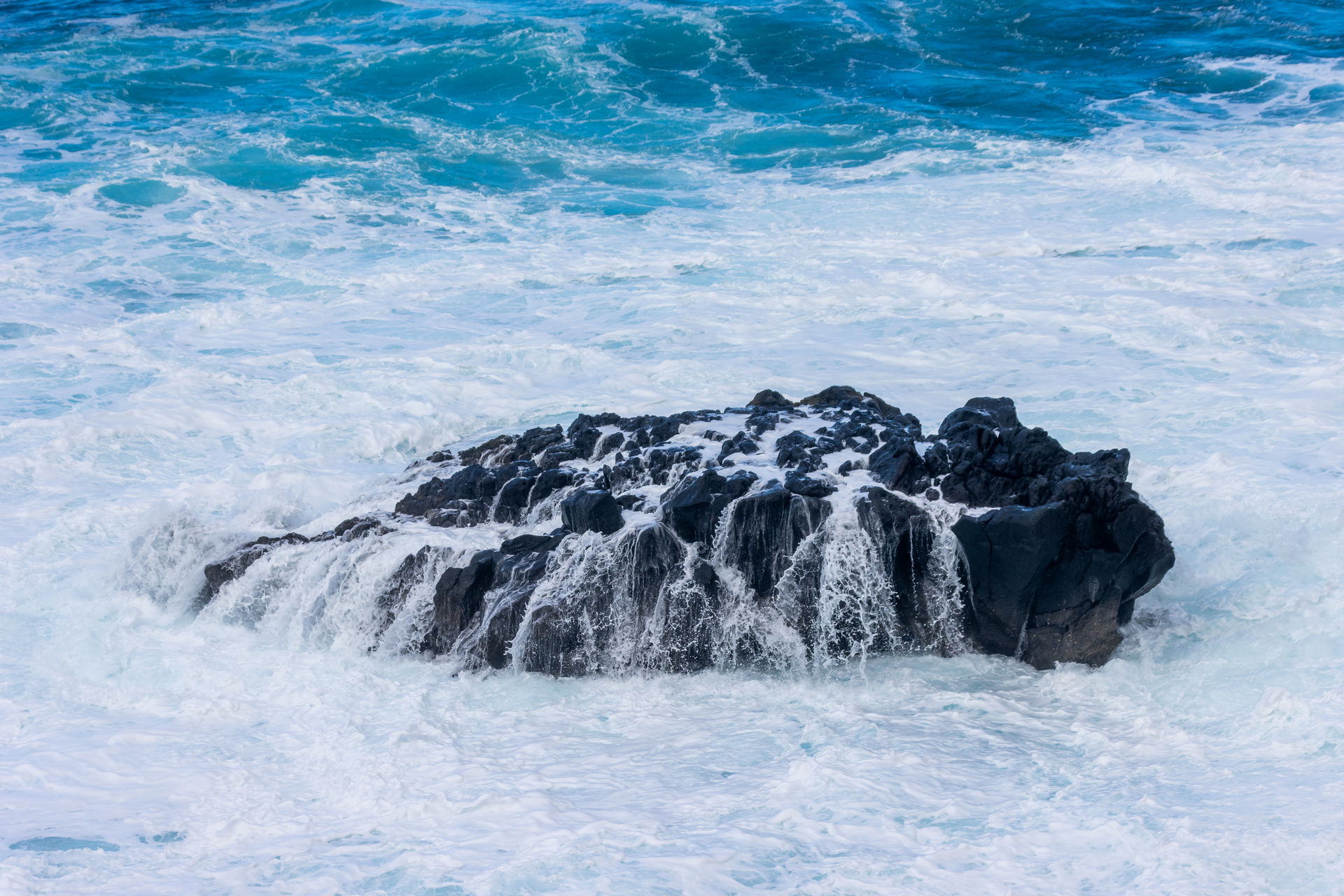 Sea water flowing off a rock at Costa El Sauzal, Tenerife